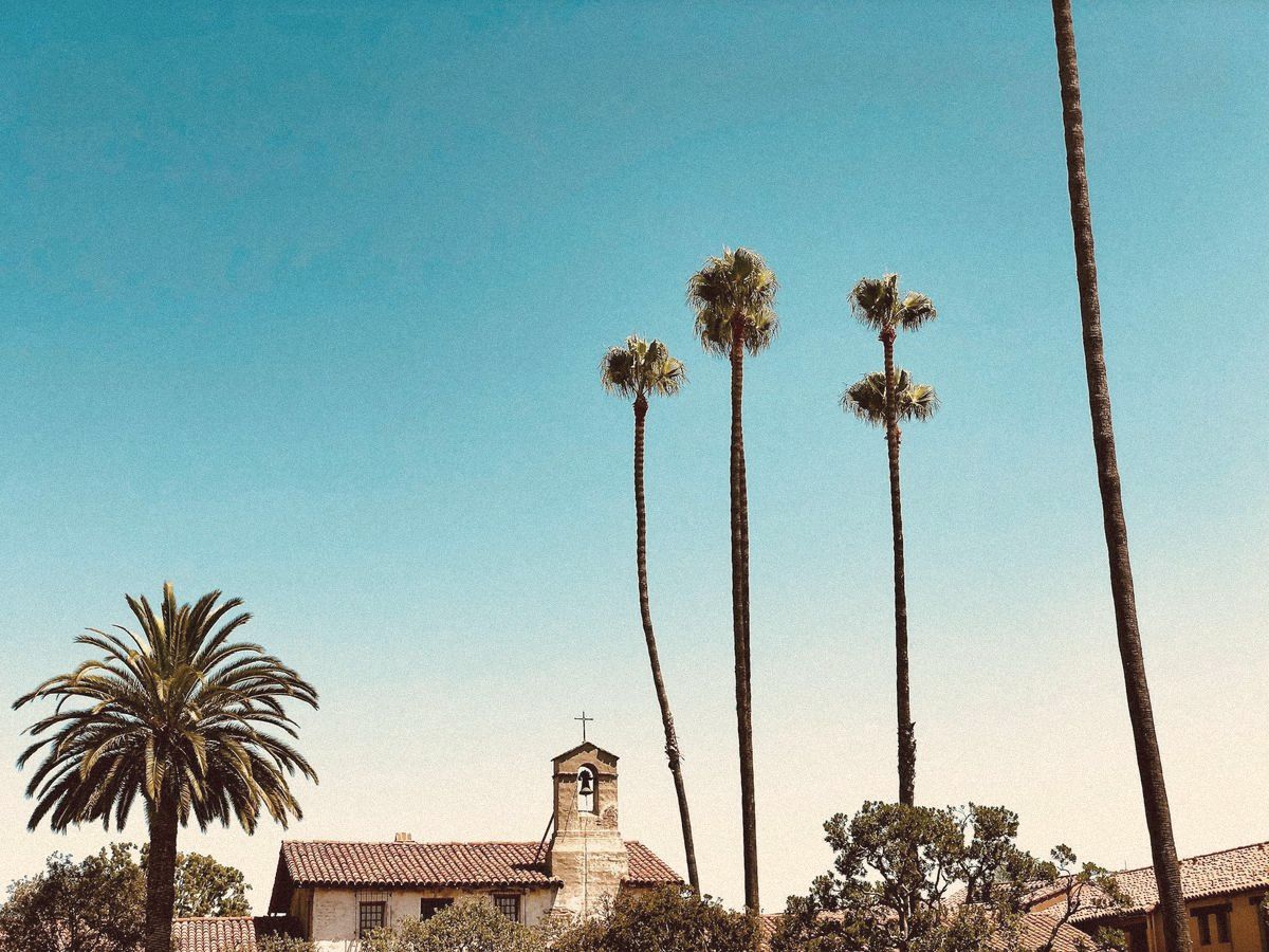 Arched walls and flowers at Mission San Juan Capistrano